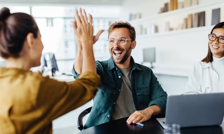 Office Personnel Celebrating and Giving High Five